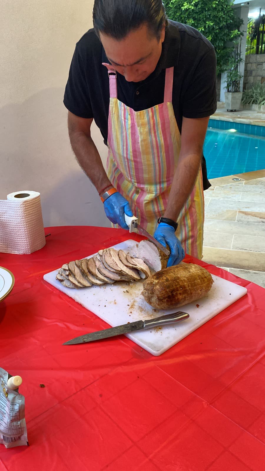 El Chino cortando un pernil con cuchillo eléctrico